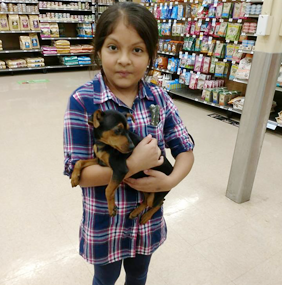 Child Holding a Puppy